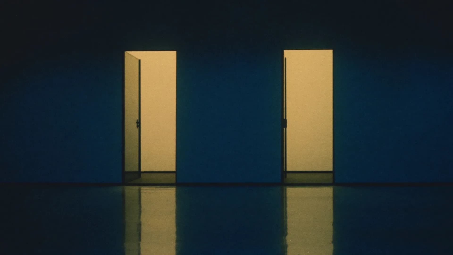 Two tall doorways side by side in a dark corridor, each glowing with warm light