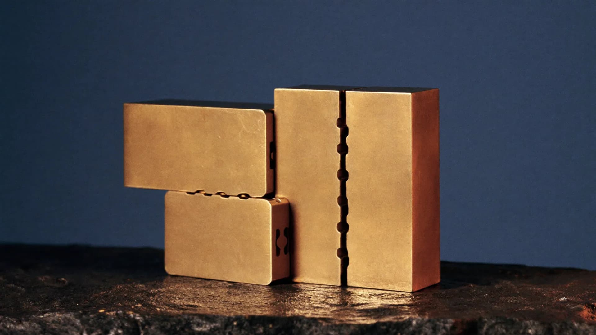 Four brass blocks with interlocking joints fitted into one structure
